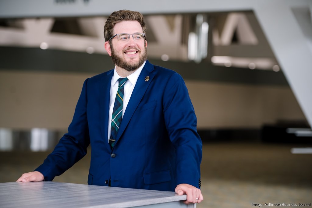 Image of Mac Campbell in blue suit, smiling