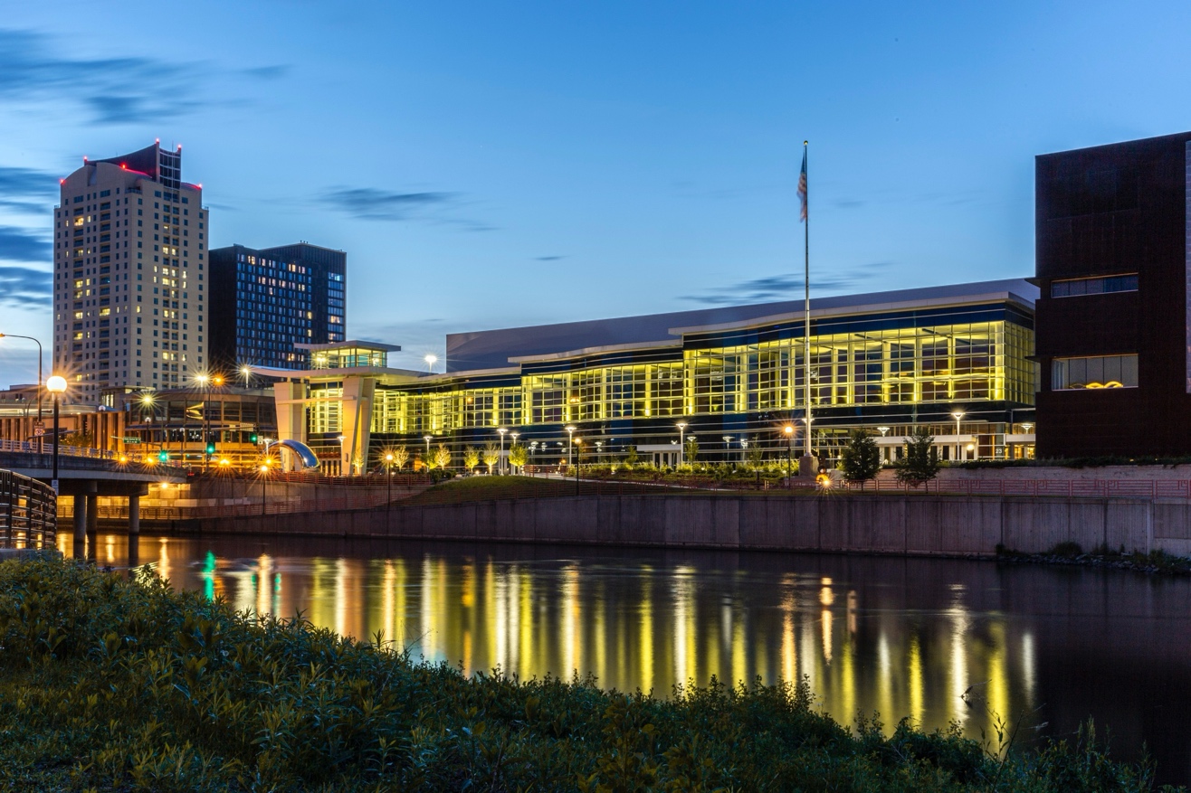 Photo of Mayo Civic Center at night with lights reflecting in water