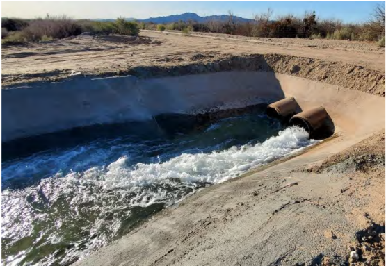 Lined canal in operation at heading discharge culvert.