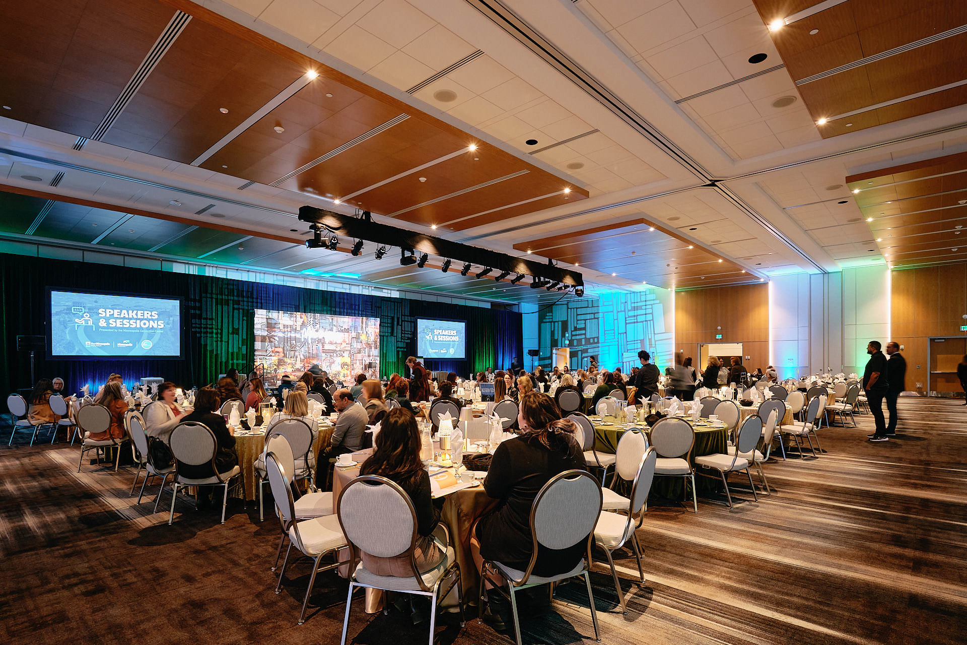 meeting room with people sitting around tables for event
